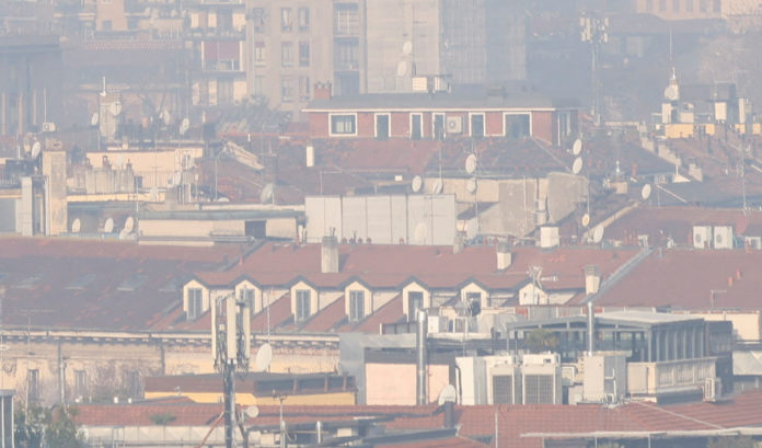 General view of high-rise buildings shrouded in smog in Milan