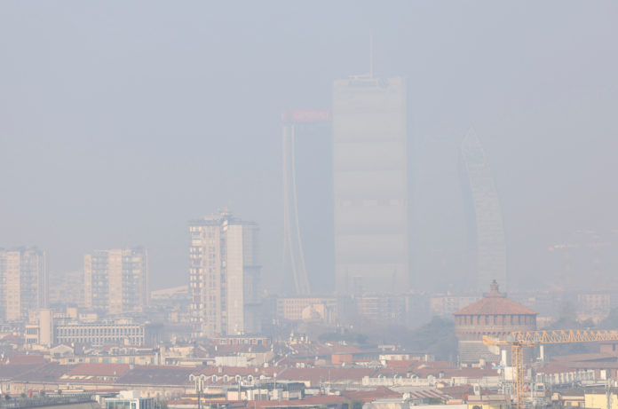 General view of high-rise buildings shrouded in smog in Milan